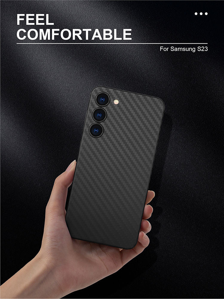 Hand holding a black phone case with 'Feel Comfortable' text on a dark background